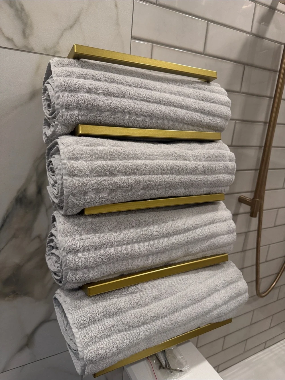 Gold Wall-Mounted Towel Rack with Green and Beige Towels - Modern Bath Storage